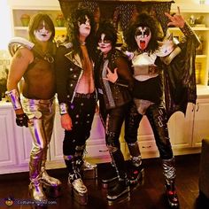 three men dressed up as kiss band members