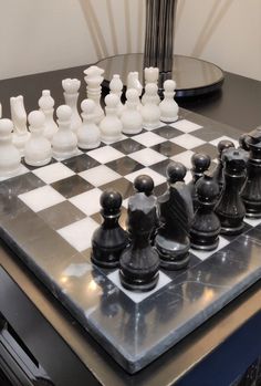 a chess board with black and white pieces on it