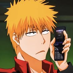 an anime character holding a cell phone up to his ear and looking at the screen