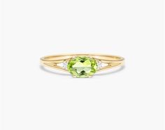 14K Yellow Gold Oval Peridot and Diamond Accent Birthstone Ring. The birthstone of August, peridot is known for its distinctive light green color and is said to bring strength, joy, prosperity, and good health to those who wear it. It is also known to bring harmony to romantic relationships and protect against evil, jealousy and even bad dreams. This delicate east-west peridot ring with accent diamonds is the perfect piece for your special someone Simpel Peridot Rings, Ruby And Peridot Rings, Peridot Engagement Rings Diamond, Light Green Color, Buying Gold, Jewelry Photoshoot, Celebrity Engagement Rings, Ring Trends, Wedding Rings Solitaire