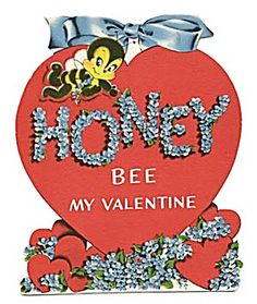 a red heart shaped box with the words honey bee my valentine on it and blue flowers