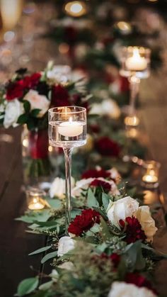 a long table with candles and flowers on it