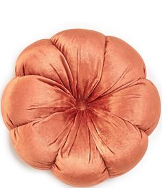 an orange round pillow on a white background