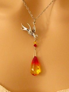 "Swarovski Phoenix Jewelry Gift for Her, Encouragement Necklace, Strength Necklace: Rebirth of an intricately detailed phoenix as it rises above the flames of a genuine Swarovski fire opal crystal in this beautiful Phoenix Necklace. This highly refractive crystal graduates from yellow to a fiery orangish red and is wire wrapped with two smaller Swarovski crystals onto the phoenix. The entire phoenix pendant hangs from a delicate antiqued silver plated chain. Phoenix Earrings: These long Swarovsk Unique Bird Design Pendant Jewelry, Fantasy Dangle Jewelry Gift, Encouragement Jewelry, Fire Necklace, Phoenix Jewelry, Phoenix Necklace, Phoenix Pendant, Fire Bird, Symbol Necklace