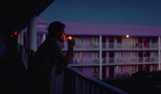 a person standing on a balcony at night