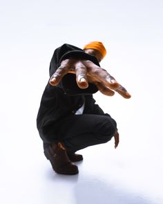 a man in black jacket doing a hand stand