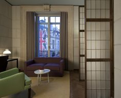 a living room filled with furniture next to a window