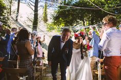 a bride and groom walking down the aisle after their wedding ceremony at an outdoor venue