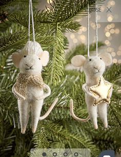 two white mice hanging from a christmas tree