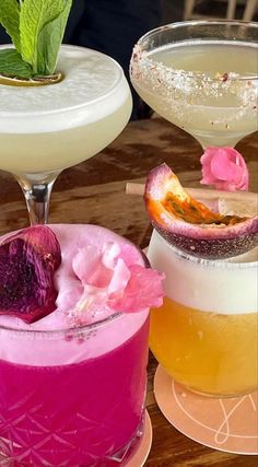 three different types of cocktails are on the table