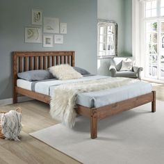 a bedroom with blue walls and wooden furniture