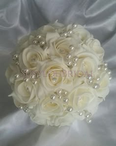 a bridal bouquet with white roses and pearls