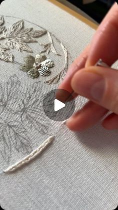 someone is stitching something on a piece of fabric