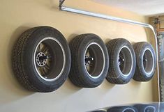 there are four tires hanging on the wall