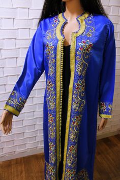 Transport yourself to the vibrant world of Morocco with our vintage blue Moroccan kaftan. This classic piece is a work of art, featuring intricate and colorful beading that adds a lively touch to its design. Whether you're wearing it for a special occasion or simply to infuse your day with a touch of elegance, this kaftan captures the spirit of Moroccan tradition. It's a timeless and versatile addition to your wardrobe, allowing you to express your unique style with every wear measurements : bus Long Festive Kaftan With Multicolor Embroidery, Festive Long Kaftan With Multicolor Embroidery, Long Multicolor Embroidered Kaftan For Festive Occasions, Long Kaftan With Multicolor Embroidery For Festive Occasions, Blue Traditional Ceremonial Kaftan, Traditional Blue Floor-length Kaftan, Blue Traditional Long Thobe, Traditional Embellished Blue Abaya, Bohemian Ceremonial Kaftan With Zari Work