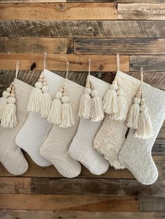 christmas stockings with tassels hanging from them