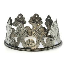 a silver tiara with flowers and leaves on it's sides, set against a white background