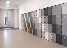 an empty room with many different colored squares on the wall and doors in the background