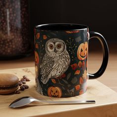 an owl is sitting on top of a coffee mug with pumpkins and jack - o'- lanterns