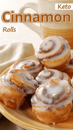 a plate topped with cinnamon rolls next to a cup of coffee