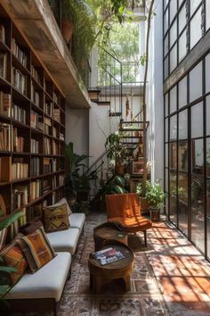 a living room filled with lots of furniture and bookshelves next to a stair case