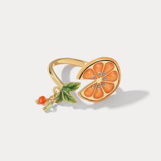 Orange Slices Ring is an adjustable ring with a slice of orange. This is a unique jewelry design from Selenichast. If you need a piece of fine jewelry or like nature jewelry, you can try for this fruit ring is at a reasonable price. ﻿Add a pop of playful color to your look with our Orange Slices Ring! Made with enamel and gold, this eye-catching accessory will make you stand out in any crowd. (Warning: may cause sudden cravings for citrus.) DETAILS Plating: 18K Gold Materials: 18K Gold on Brass, Orange Blossum Rings, Trendy Cheap Jewelry With Fruit Design, Resin Fruit Rings, Cheap Playful Jewelry With Fruit Design, Cheap Playful Fruit Design Jewelry, Orange Slice Jewelry, Cheap Playful Fruit-designed Jewelry, Unique Orange Jewelry For Gifts, Unique Orange Jewelry For Gift