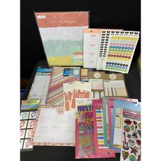 the contents of a planner spread out on a table with papers and stickers in it