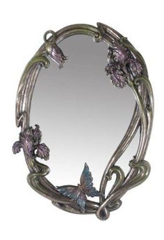 a mirror that has flowers on it and a butterfly in the middle with leaves around it