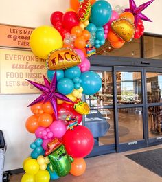 an entrance decorated with balloons and confetti in the shape of starfishs