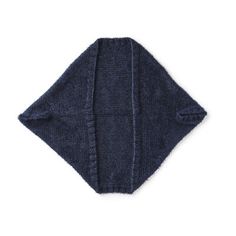 a dark blue towel folded up on top of a white surface with the corner cut out