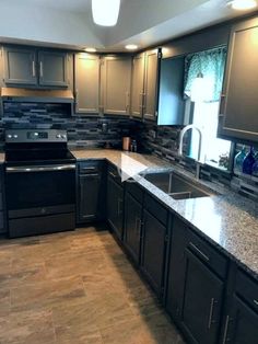 a kitchen with granite counter tops and stainless steel appliances on the counters, along with dark wood cabinets