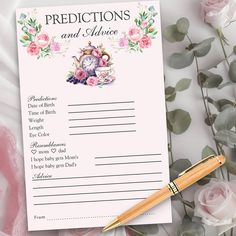 a pink rose themed wedding advice card next to a pen and flowery bouquet with roses