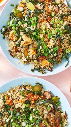 two plates filled with rice and vegetables on top of a table