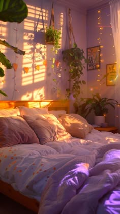 a bed sitting under a window next to a potted plant