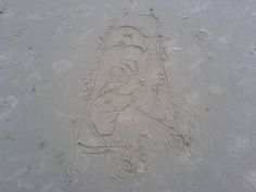 a drawing in the sand that looks like a baseball player