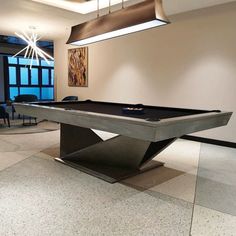 a pool table is in the middle of a room