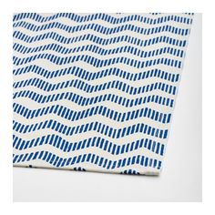 a blue and white napkin with wavy lines on it