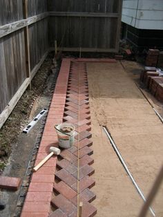 a brick walkway being built in the back yard