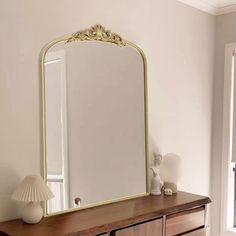 a large mirror sitting on top of a wooden dresser