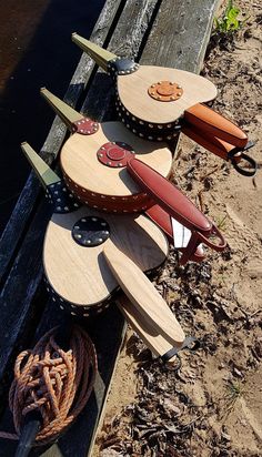 several different types of knives are stacked on top of each other near a wooden bench