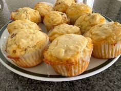 several muffins on a plate sitting on a table