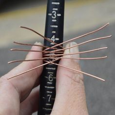 a person holding some kind of wire in their hand