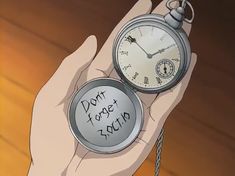 a person holding an alarm clock with the words don't forget it again written on it