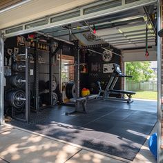 the inside of a home gym with several machines and weight plates on it's walls