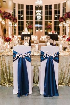 two chairs covered in blue sashes with the word groom and bride on them