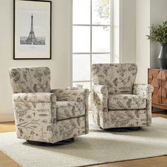 two chairs sitting on top of a rug in front of a window