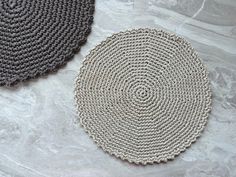 two circular rugs sitting next to each other on a table