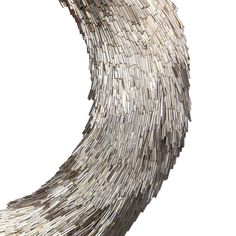 an abstract sculpture made out of strips of wood and metal, against a white background