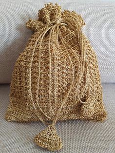 a crocheted bag sitting on top of a couch