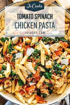 a skillet filled with pasta, chicken and spinach